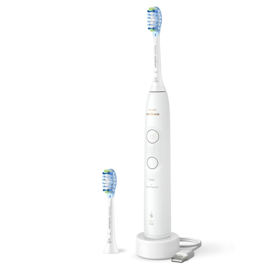 Philips Sonicare Series 5900 handle in white with a spare C3 brush head and a USB charging base